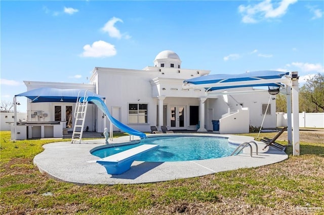 4004 Persimmon Dr, Palmhurst, TX 78573 - view of swimming pool featuring french doors, a water slide, a patio area, and a diving board