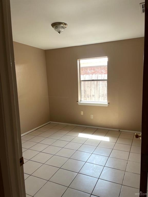 1017 El Recreo Cir, Edinburg, TX 78539 - unfurnished room with light tile patterned floors and baseboards