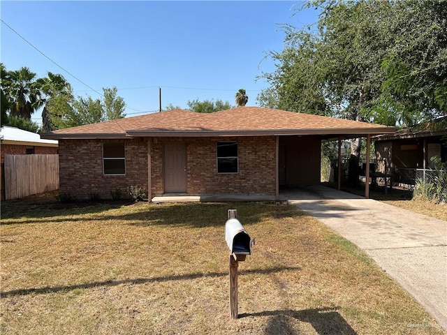 1017 El Recreo Cir, Edinburg, TX 78539 - view of front of house with driveway, brick siding, a shingled roof, and a carport