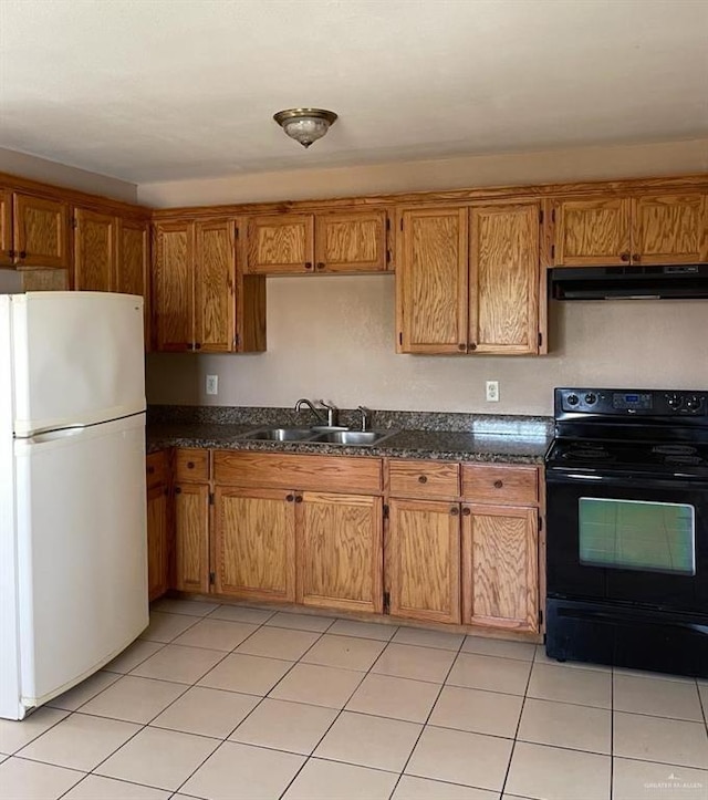 1017 El Recreo Cir, Edinburg, TX 78539 - kitchen featuring freestanding refrigerator, black range with electric stovetop, under cabinet range hood, and brown cabinetry