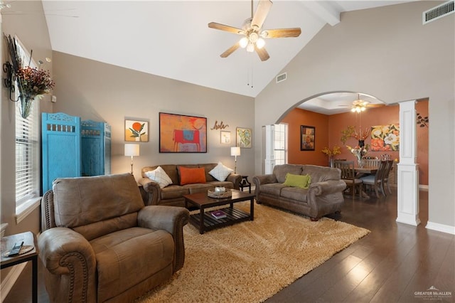 living room with beam ceiling, ornate columns, ceiling fan, dark hardwood / wood-style flooring, and high vaulted ceiling