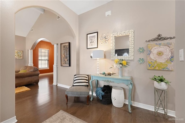 living area featuring dark hardwood / wood-style flooring and vaulted ceiling