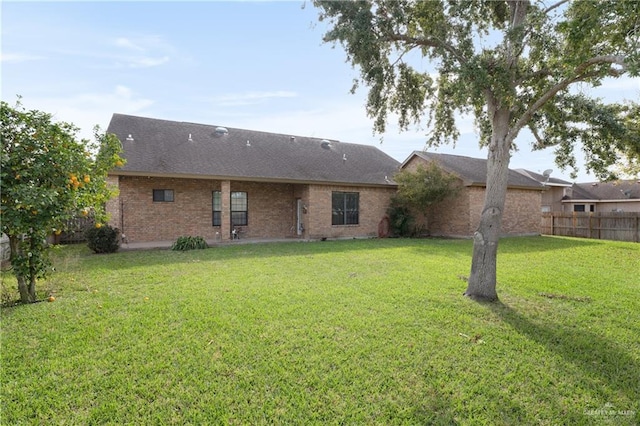 back of property featuring a lawn