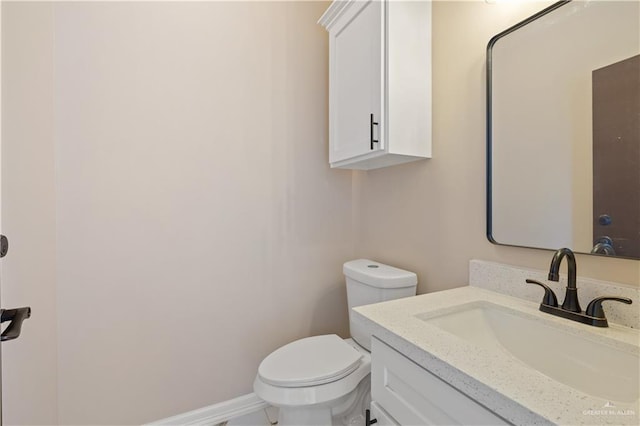 727 N Milam St, San Benito, TX 78586 - bathroom featuring vanity, toilet, and baseboards