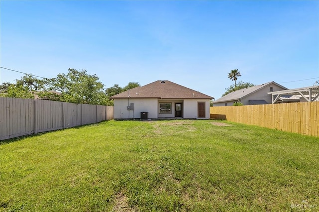 727 N Milam St, San Benito, TX 78586 - rear view of property featuring central AC and stucco siding