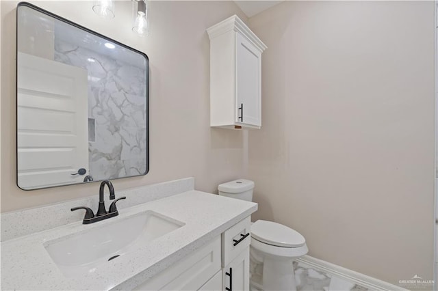 727 N Milam St, San Benito, TX 78586 - bathroom with marble look tile flooring, toilet, and vanity