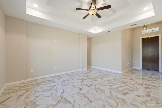 727 N Milam St, San Benito, TX 78586 - unfurnished room featuring recessed lighting, a tray ceiling, light marble finish floors, a ceiling fan, and baseboards