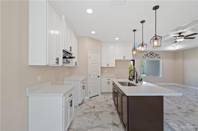 727 N Milam St, San Benito, TX 78586 - kitchen with a sink, light marble finish floors, recessed lighting, ceiling fan, and under cabinet range hood