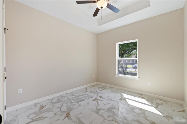 727 N Milam St, San Benito, TX 78586 - unfurnished room with light marble finish flooring, a ceiling fan, and baseboards