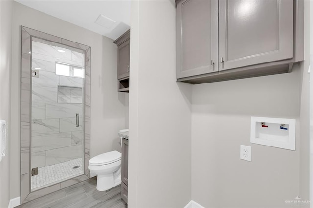 bathroom featuring toilet and a marble finish shower