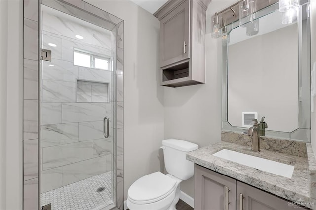 full bathroom with toilet, visible vents, vanity, baseboards, and a shower stall