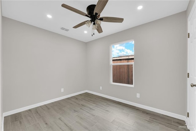 spare room featuring light wood finished floors, recessed lighting, visible vents, a ceiling fan, and baseboards