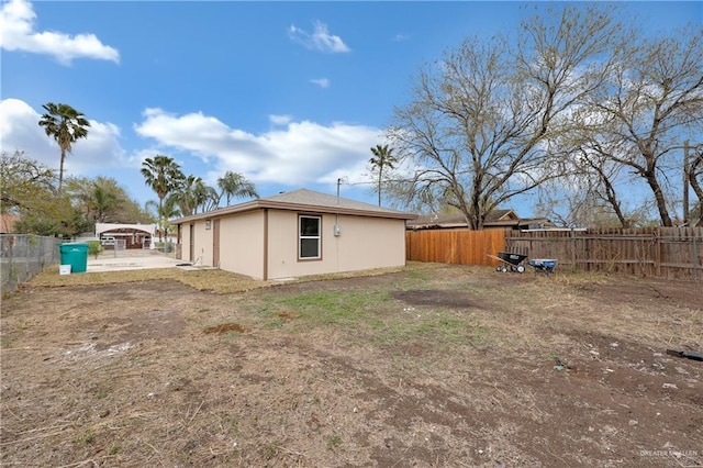 back of property with a fenced backyard