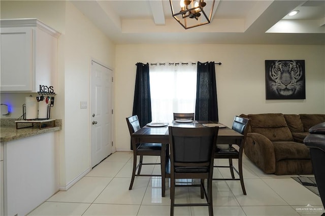 dining area featuring light tile patterned flooring and an inviting chandelier