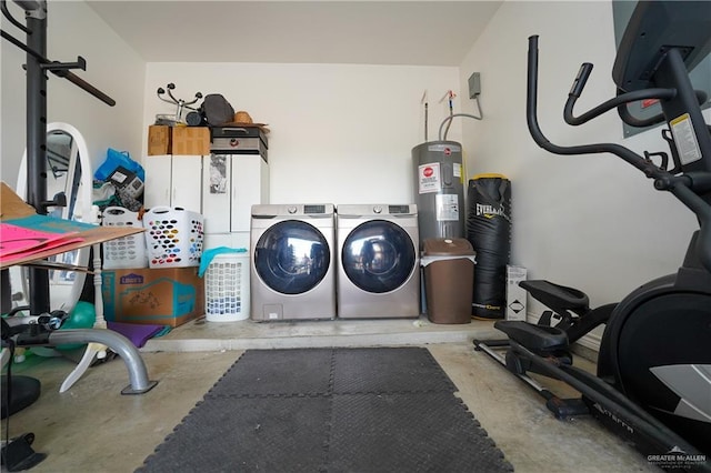 clothes washing area featuring electric water heater and washing machine and clothes dryer