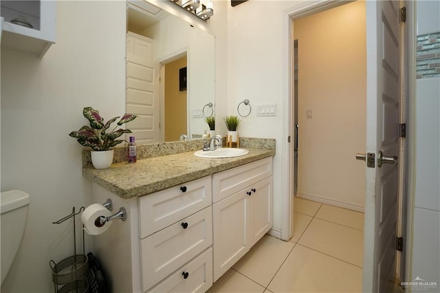 bathroom featuring tile patterned floors, toilet, and vanity