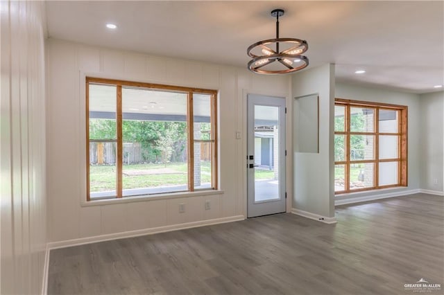 doorway featuring a chandelier, dark hardwood / wood-style floors, and plenty of natural light