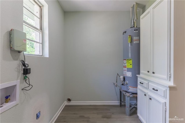 clothes washing area featuring hardwood / wood-style floors, electric dryer hookup, gas water heater, and washer hookup