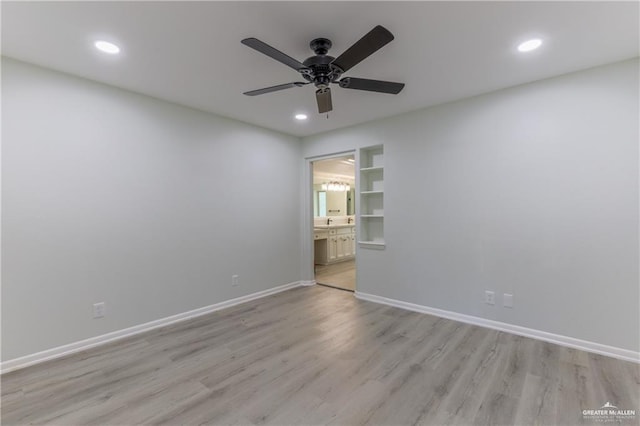 spare room with ceiling fan and light hardwood / wood-style flooring