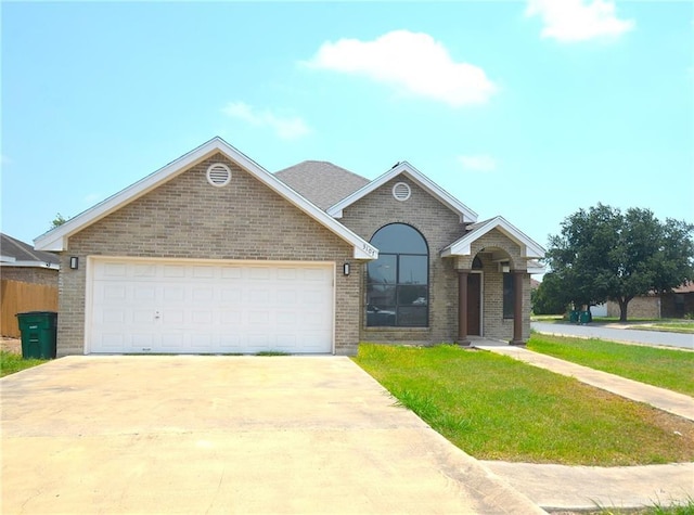 3107 E Laurel St, Hidalgo, TX 78557 - view of front of house featuring brick siding, driveway, a front lawn, and a garage