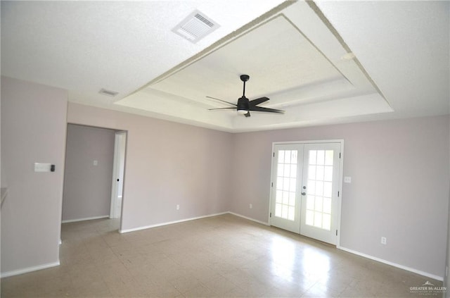 3107 E Laurel St, Hidalgo, TX 78557 - empty room featuring a raised ceiling, ceiling fan, french doors, and tile patterned floors