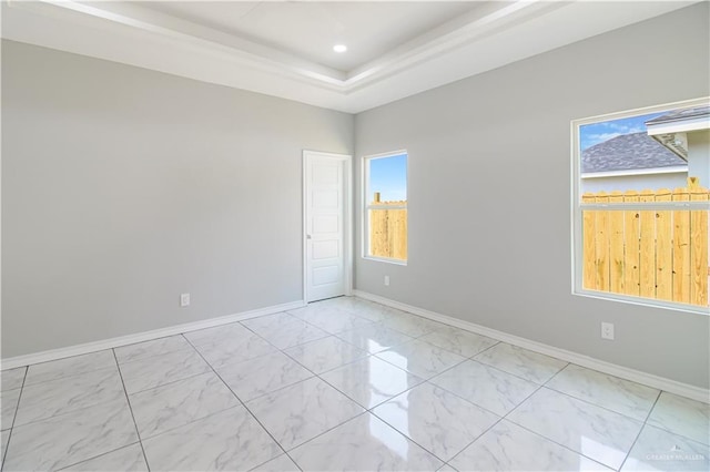2025 Trinity St, Donna, TX 78537 - empty room with light marble finish floors, baseboards, a tray ceiling, and recessed lighting
