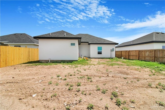 2025 Trinity St, Donna, TX 78537 - rear view of house with a fenced backyard, stucco siding, and roof with shingles