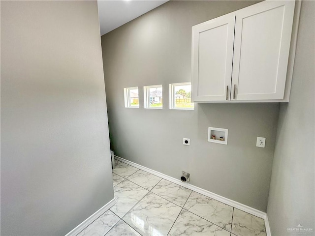 2025 Trinity St, Donna, TX 78537 - laundry area featuring light marble finish flooring, hookup for an electric dryer, hookup for a washing machine, cabinet space, and baseboards