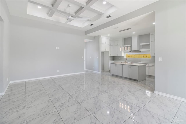 2025 Trinity St, Donna, TX 78537 - kitchen with ceiling fan, open shelves, light marble finish floors, baseboards, and beamed ceiling