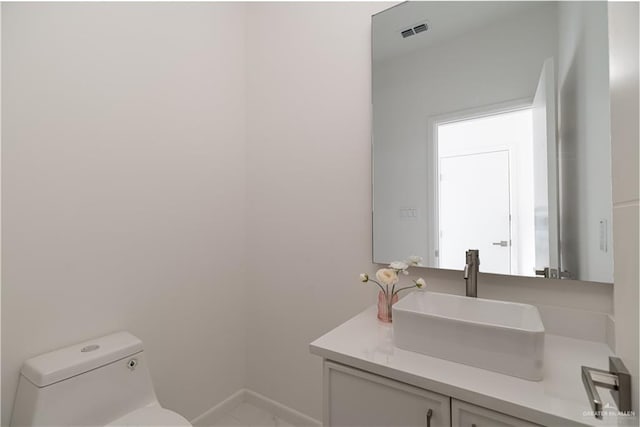2711 Harmony St, Mission, TX 78574 - half bathroom featuring visible vents, baseboards, toilet, and vanity
