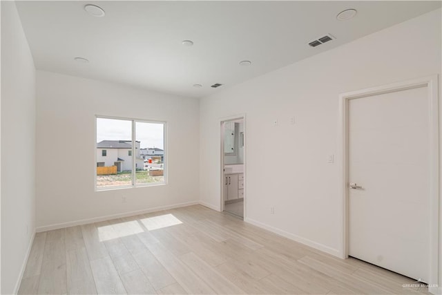 2711 Harmony St, Mission, TX 78574 - unfurnished bedroom with baseboards, visible vents, and light wood-style floors