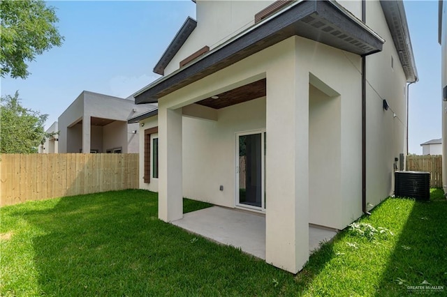 2711 Harmony St, Mission, TX 78574 - back of property featuring a yard, fence, central AC unit, and stucco siding