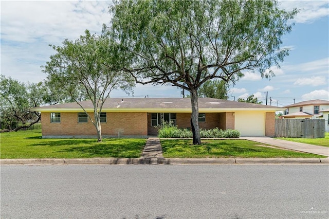 206 E Ricky Crossland Ave, Elsa, TX 78543 - single story home with brick siding, an attached garage, and driveway