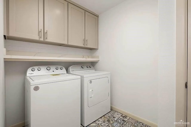 laundry area with baseboards, cabinet space, and washing machine and clothes dryer