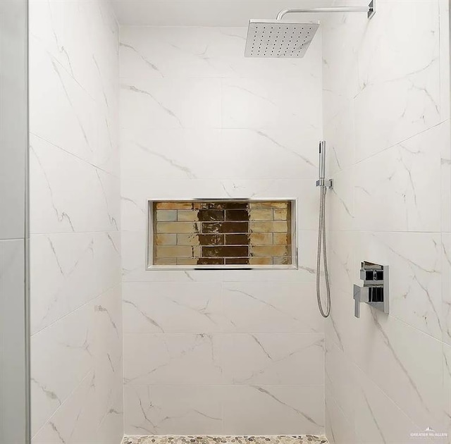 bathroom with tiled shower