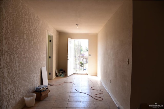 hall with light tile patterned floors