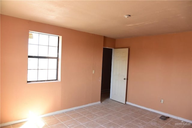 empty room with light tile patterned flooring