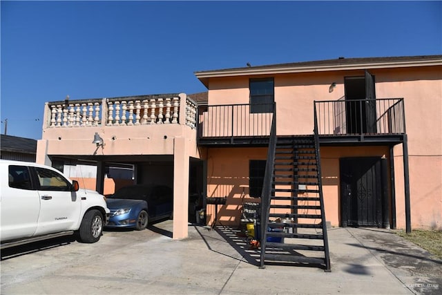 view of front of home featuring a carport and a balcony