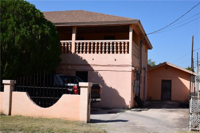 view of side of home featuring a balcony