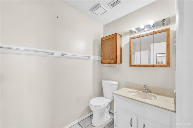 1700 E 23rd St Unit 15, Mission, TX 78574 - bathroom featuring tile patterned floors, vanity, and a textured ceiling