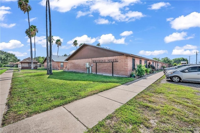 1700 E 23rd St Unit 15, Mission, TX 78574 - view of side of property featuring brick siding and a yard