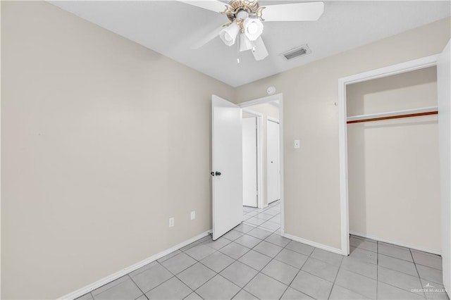 1700 E 23rd St Unit 15, Mission, TX 78574 - unfurnished bedroom with light tile patterned floors, a closet, and a ceiling fan