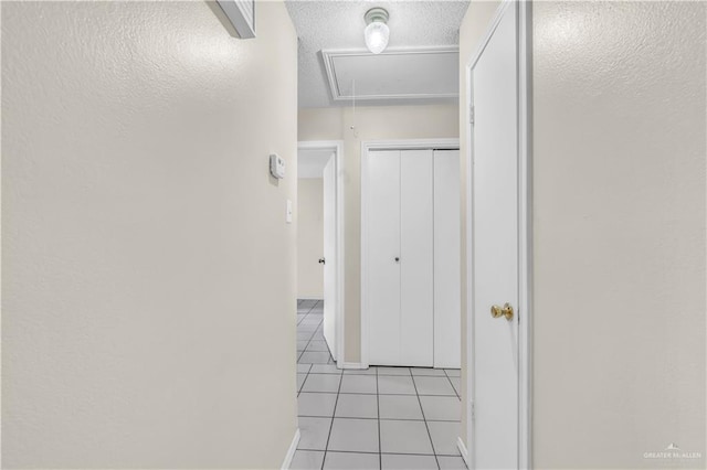 1700 E 23rd St Unit 15, Mission, TX 78574 - hallway featuring attic access, light tile patterned floors, and a textured ceiling