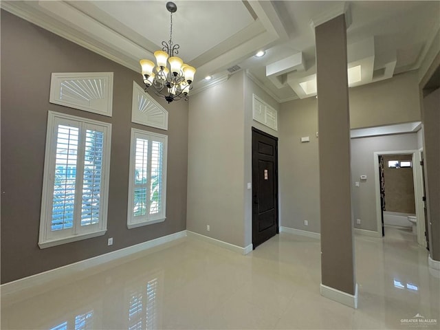 spare room featuring an inviting chandelier and ornamental molding