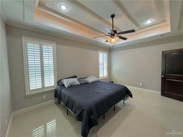 bedroom featuring a raised ceiling, ceiling fan, light tile patterned floors, and ornamental molding