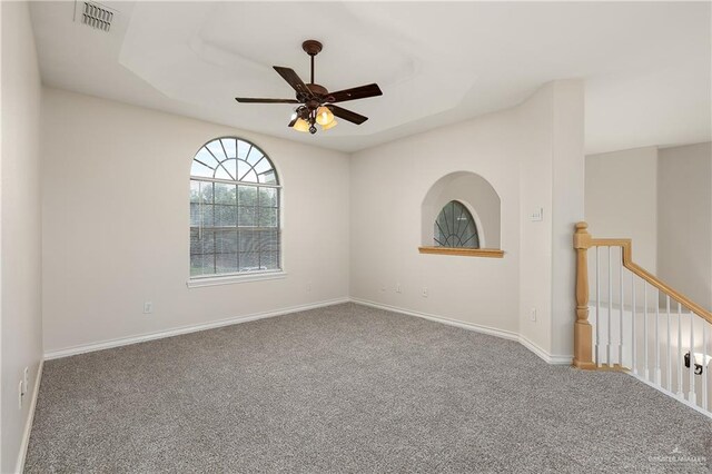 carpeted spare room with ceiling fan