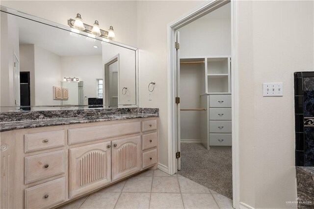 bathroom featuring tile patterned flooring and vanity