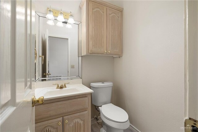 bathroom featuring vanity and toilet