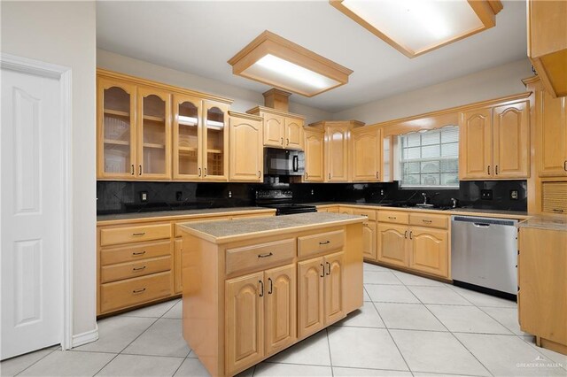 kitchen featuring backsplash, a center island, black appliances, and light brown cabinets