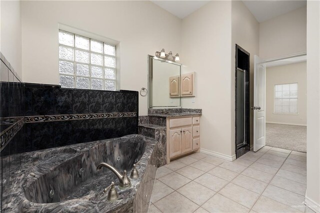 bathroom featuring a tub, plenty of natural light, and tile patterned flooring